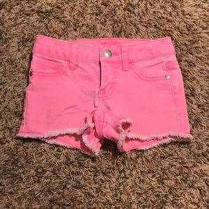 Bright pink shorts with stringy bottom